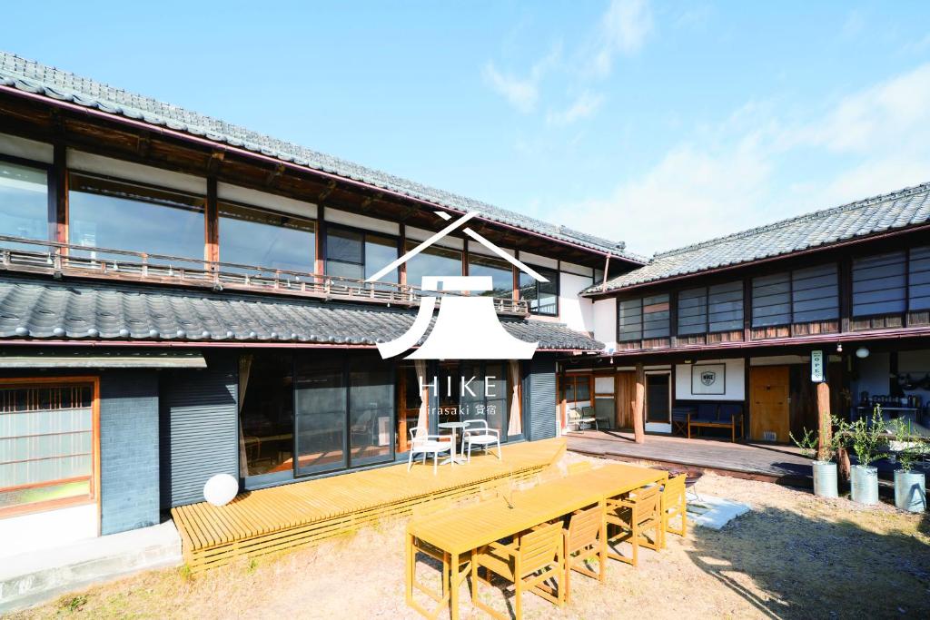 ein Gebäude mit einem Holztisch und Bänken davor in der Unterkunft Vacation rental HIKE in Nirasaki