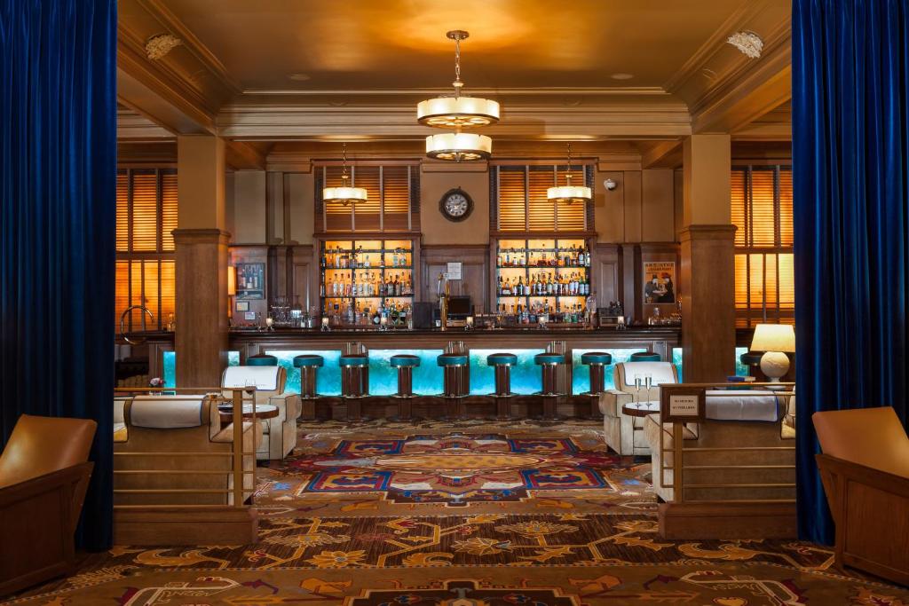a bar with blue stools in a room at Arctic Club Hotel in Seattle