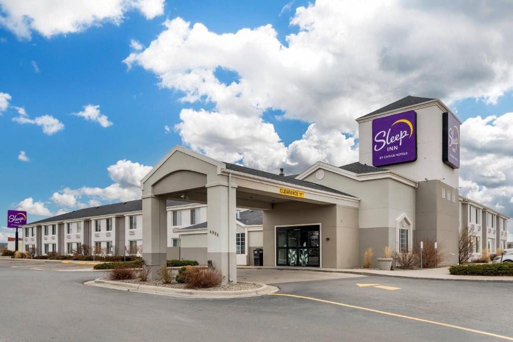 a large building with a sign on top of it at Sleep Inn Billings in Billings