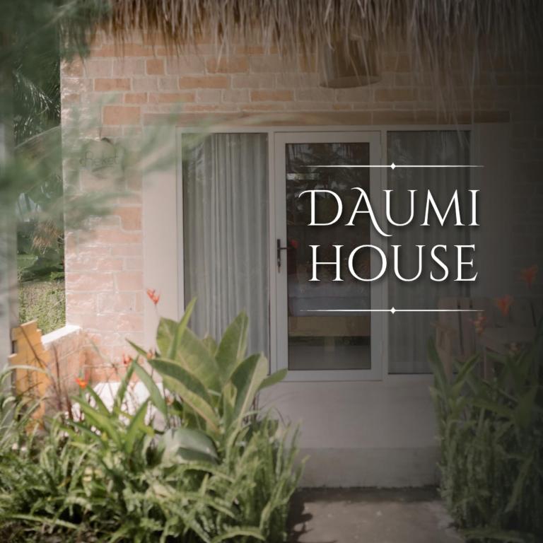 a front door of a house with a dum house sign at Daumi House in Masbagik