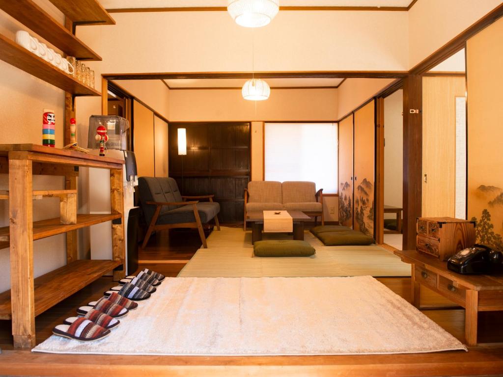a room with skis on the floor of a room at Vegestay Nonaka in Tanabe