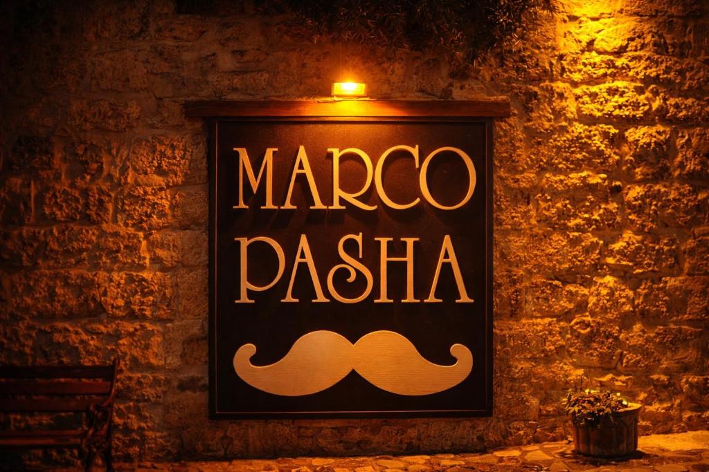 a sign that says marco pasta on a brick wall at Osmanli Marco Pasha Hotel in Tarsus