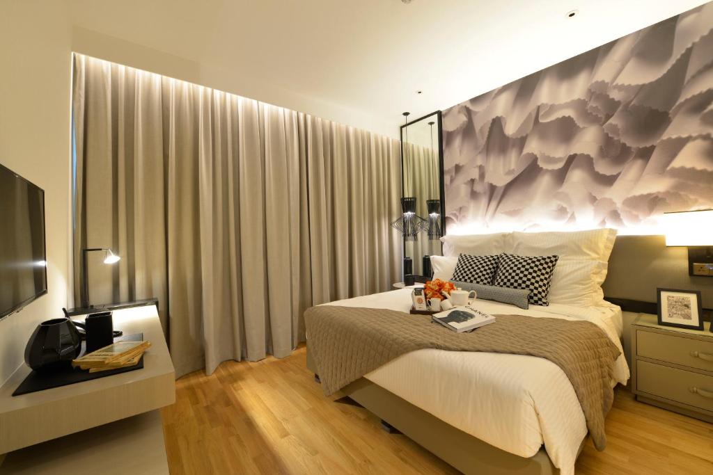 Giường trong phòng chung tại Ascott Orchard Singapore