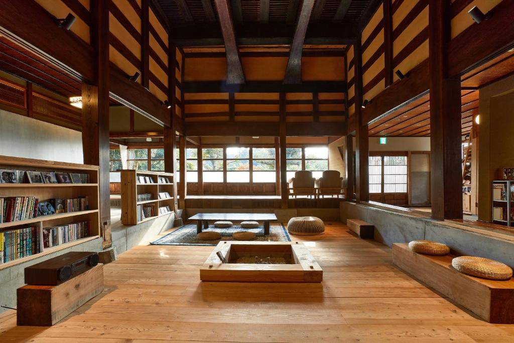 a large room with a library with a tub in it at kitanUOZU in Uozu