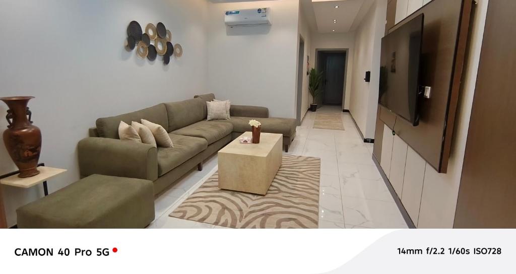 a living room with a couch and a table at Al Amer Apartment2 in Jeddah