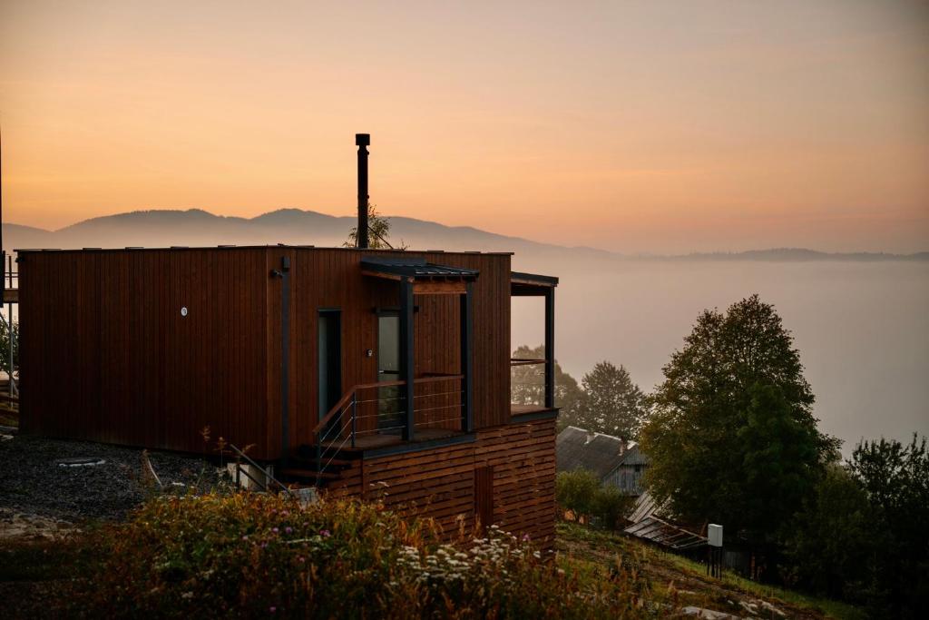 a small building on a hill with a view of the ocean at Shepit space in Slavske