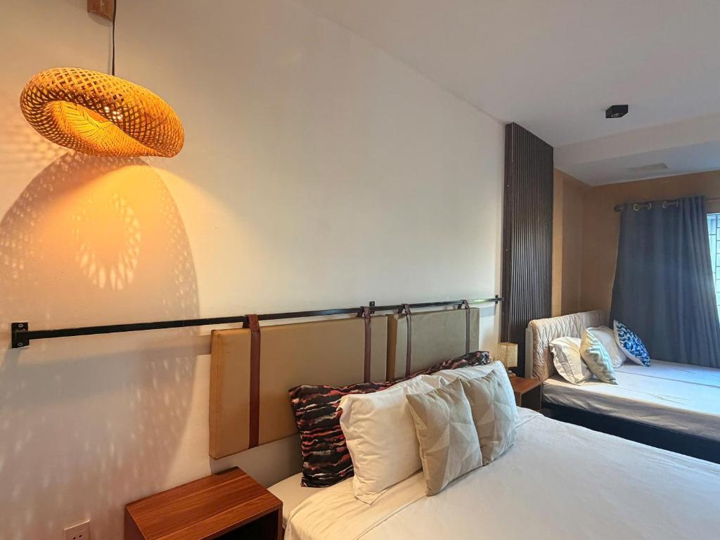 a hotel room with a bed and a window at Lynk Stay Hoian in Hoi An