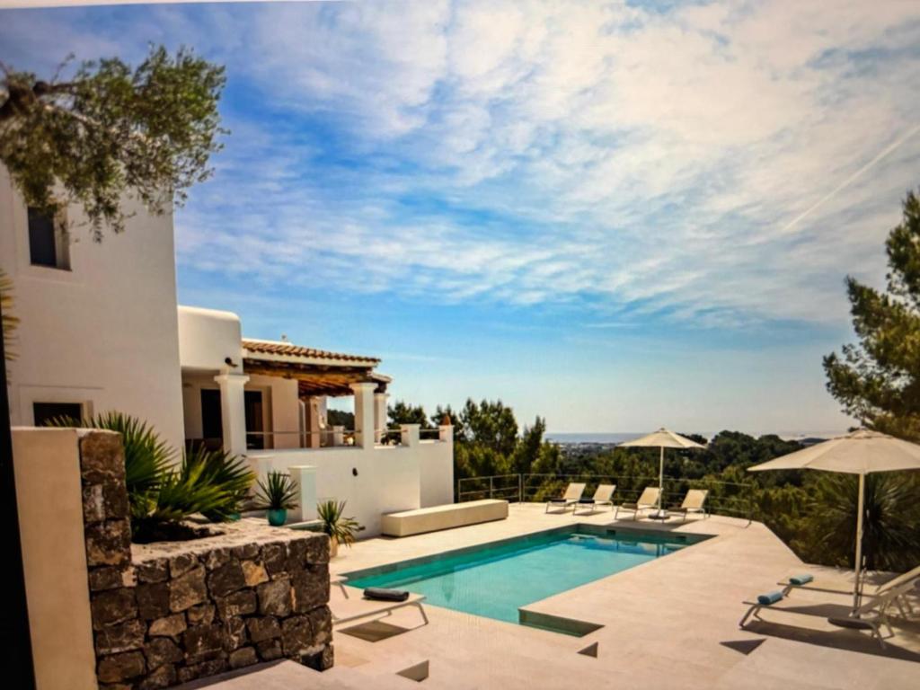 a villa with a swimming pool and a patio at Villa Casiopea in Illes Balears
