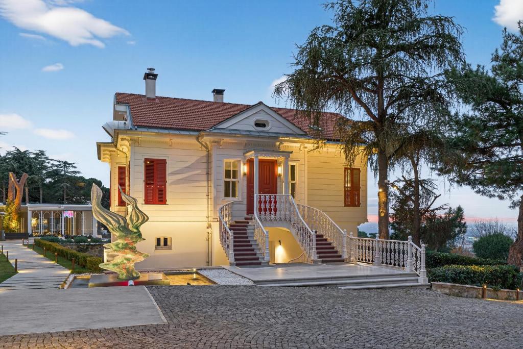 a yellow house with stairs in front of it at Arbor Hotel - Signature Collection in Istanbul