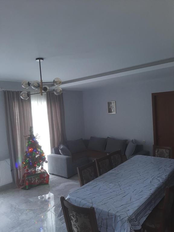 a living room with a christmas tree and a bed at Cozy Cottage Bakuriani in Bakuriani