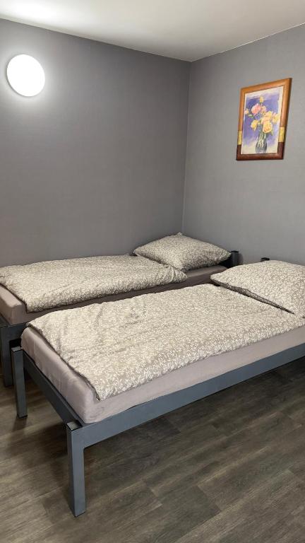 a room with three beds in a room at Apartament 10 Słoneczna in Ełk