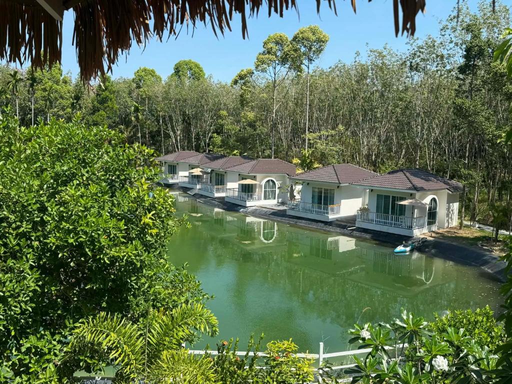 a row of cottages on the river at Hidden Haven Resort Koh Lanta in Ko Lanta