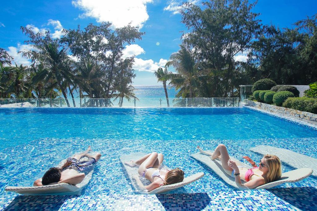 three women laying on their beds in a swimming pool at Boracay Uptown in Boracay