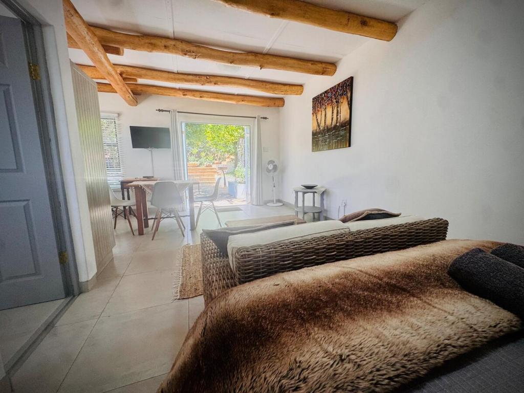 a living room with two beds and a table at Intimate Studio for Two at Hebron Estate in Piketberg