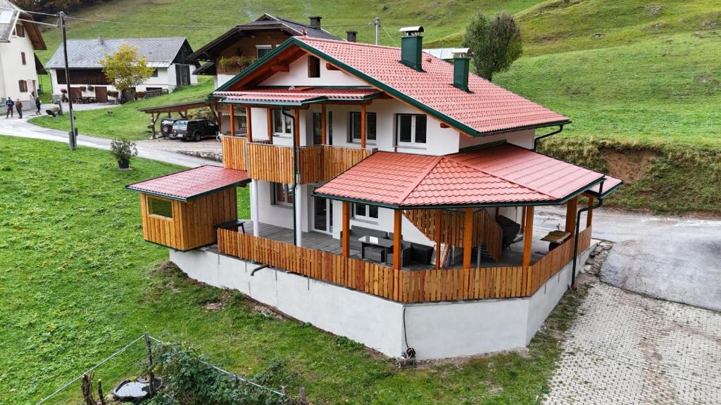 a small house with a red roof on a hill at Ferienhaus Skarbina in Zell-Pfarre