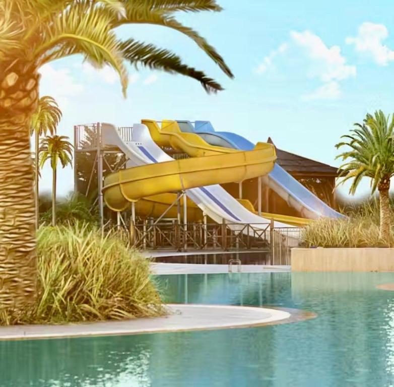 a water park with a slide and a swimming pool at Alodger Sirius Town Lara in Aksu