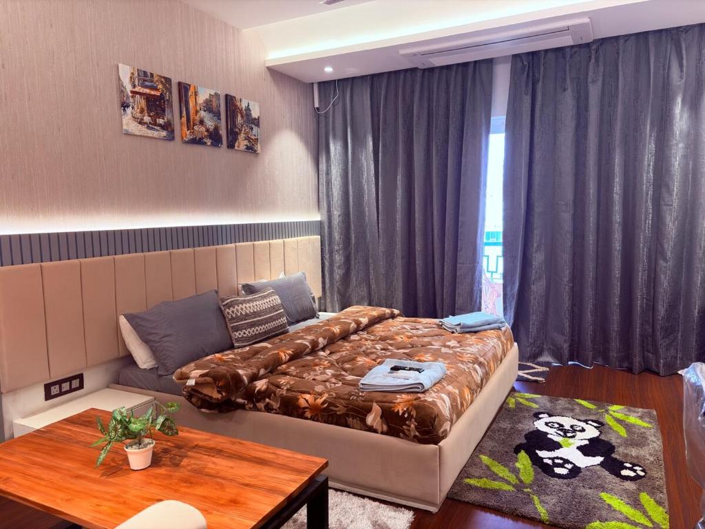 a bedroom with a bed and a couch and a table at Luxury Couple Friendly Studio in Dehradun
