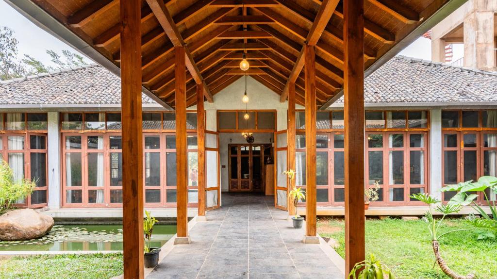 an open porch of a house with a wooden roof at Elite Villa - By Purvish Hospitalities in Bangalore
