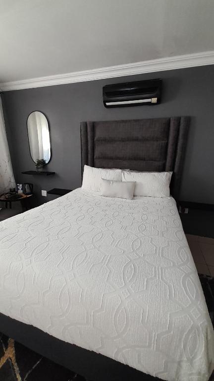 a bedroom with a large bed with a white comforter at Palma Spaces in Pretoria