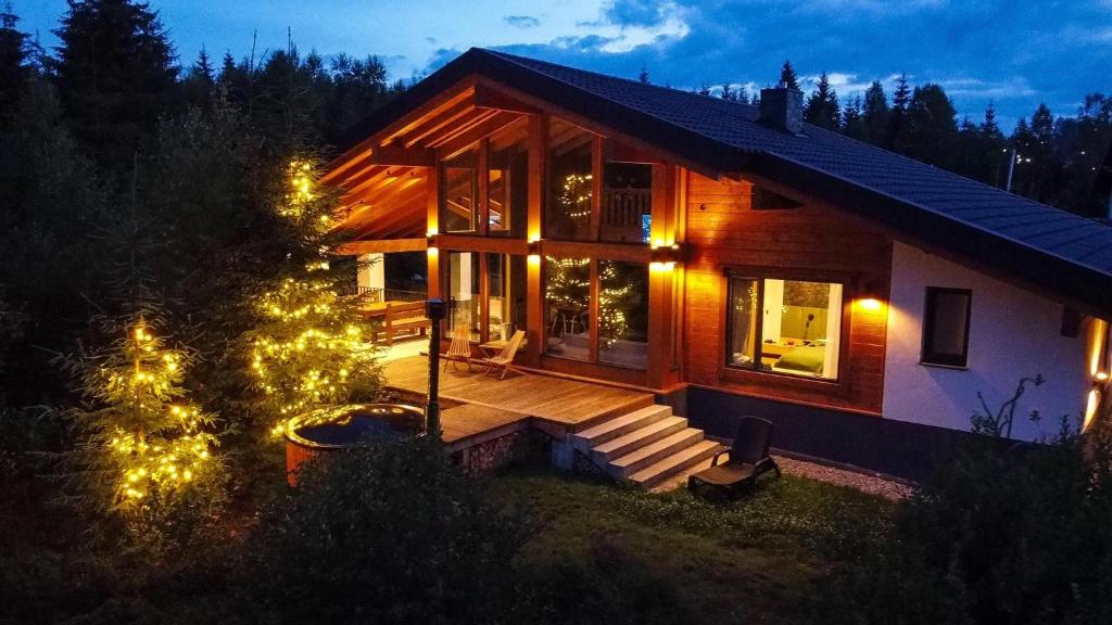 a house with a christmas tree in front of it at MOKHY Chalet & Nature in Vorokhta