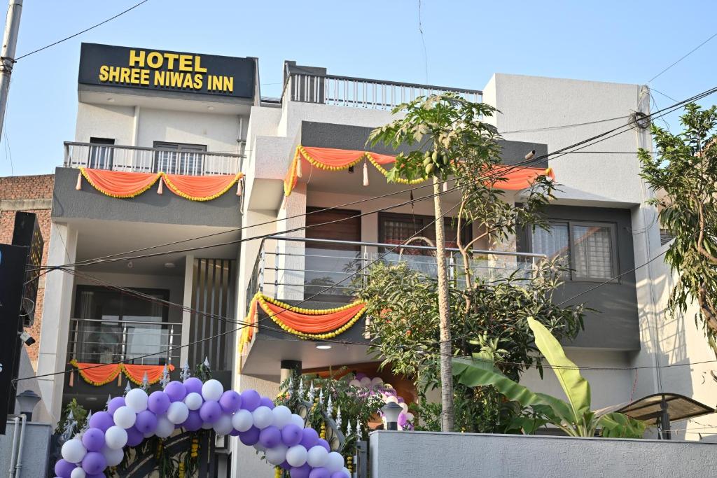 a hotel with purple balloons in front of a building at Hotel Shree Niwas Inn Near Airport in Jāmb