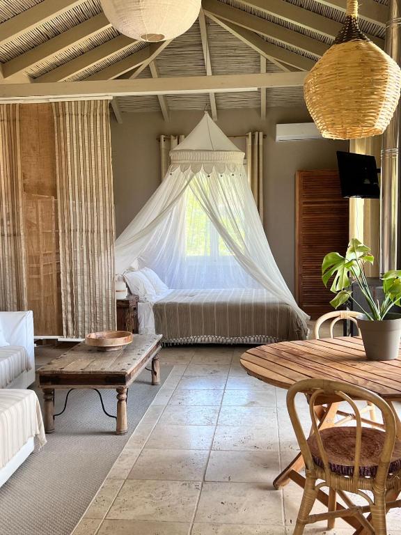 a living room with a bed and a table at FOS Ionian Breeze Studio in Platithriás