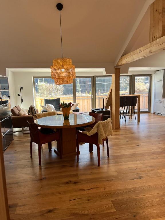 a living room with a table and a couch at Ari Apartment Wald am Arlberg in Wald am Arlberg