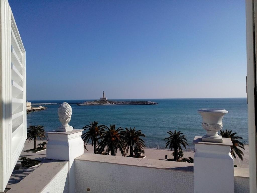 a view of the ocean with a lighthouse in the distance at B&B Marina Piccola in Vieste