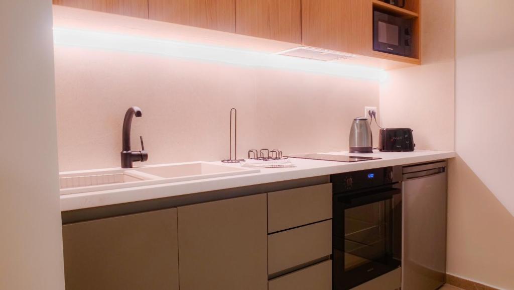 a kitchen with a sink and a stove at Cosmos Residences in Vasiliki