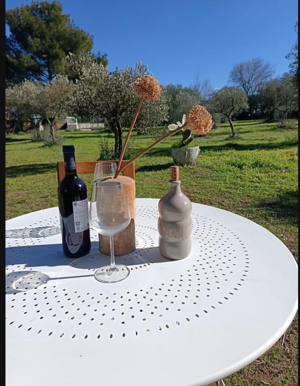 a table with two bottles of wine and a glass at B&B Antica Neviera in Gioia del Colle