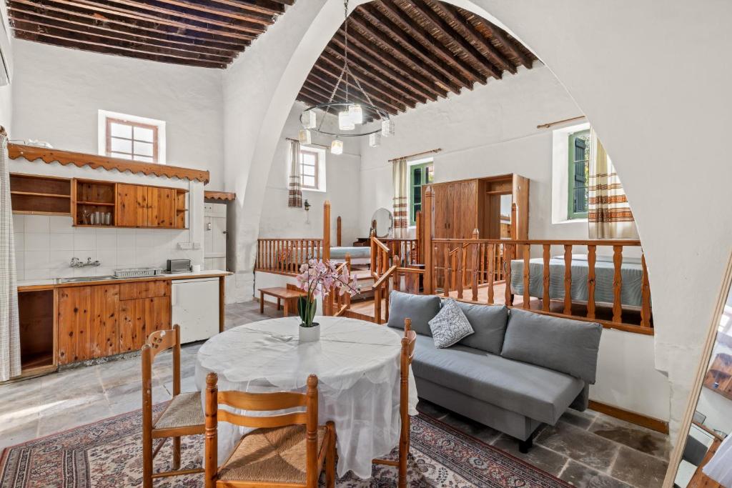 a living room with a table and a couch at Antonys Garden House in Episkopi Limassol