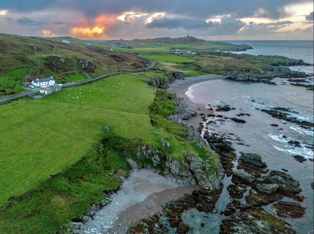 an aerial view of a beach with the ocean at Scenic Oceanfront Retreat- Buliban Cottage in Ballyhillin