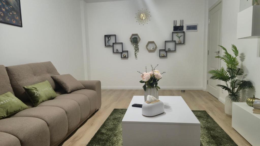 a living room with a couch and a coffee table at Zanora apartment's in Aiud