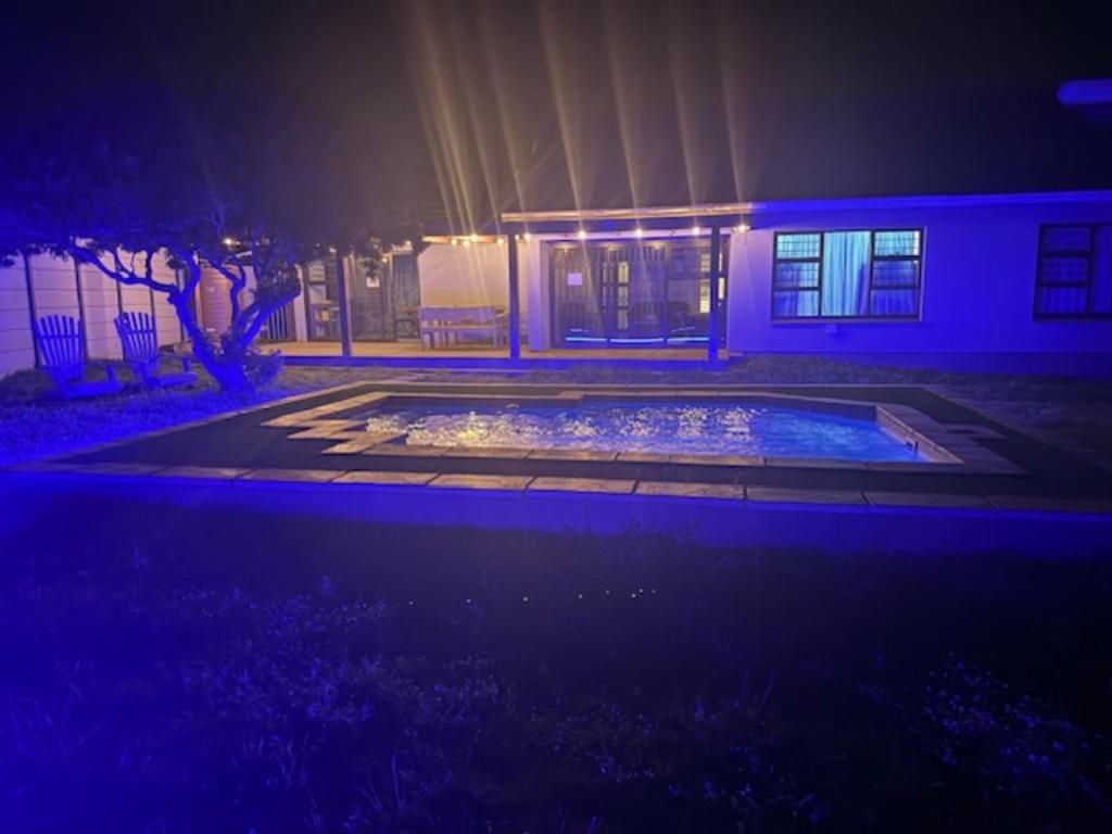 a house with a pool in the yard at night at Silva Dolphin in Vredenburg