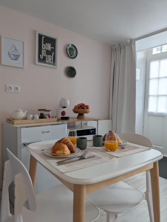 a kitchen with a table with a plate of food on it at La loge Diane, à deux pas du château et son jardin à la française in Chantilly