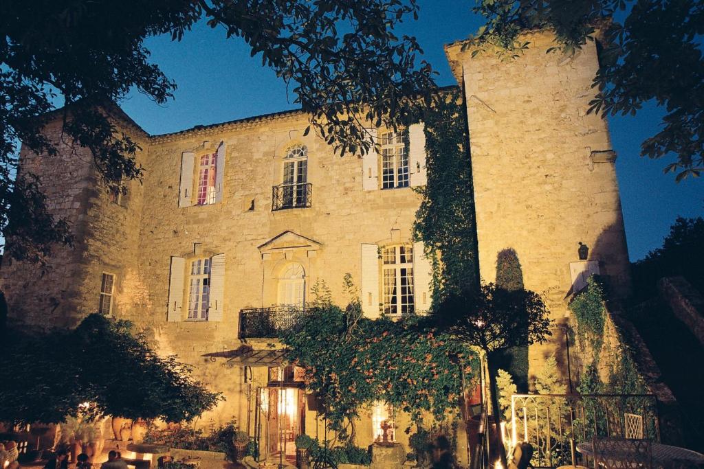 un gran edificio de piedra con una gran torre en Château d'Arpaillargues - TERITORIA en Arpaillargues-et-Aureillac