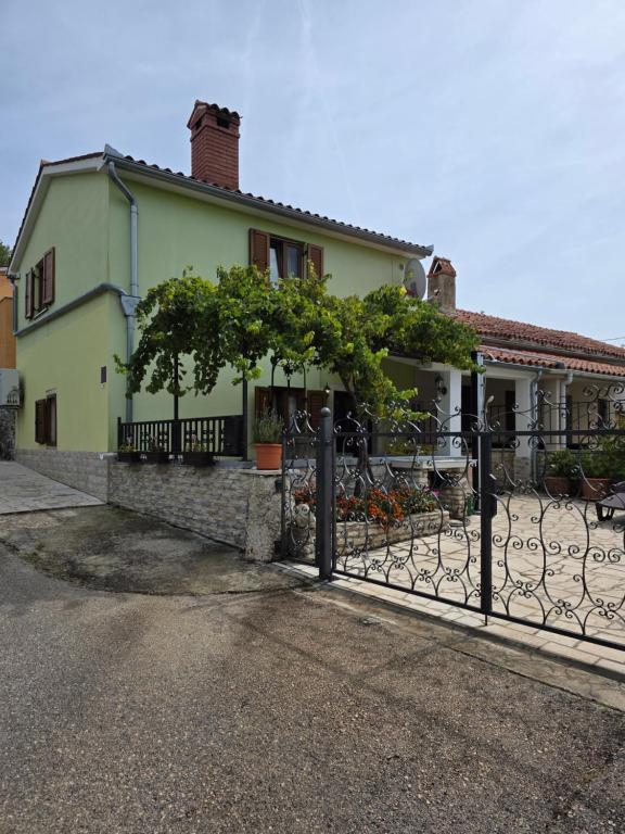 a house with a fence in front of it at House Belavici in Hreljići