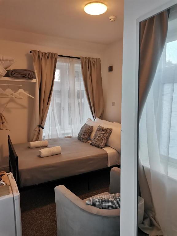 a small bedroom with a bed and a window at A to B Hotel in London