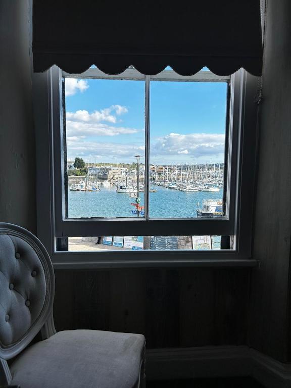 a window in a room with a view of a harbor at Admiral MacBride Bed & Breakfast in Plymouth