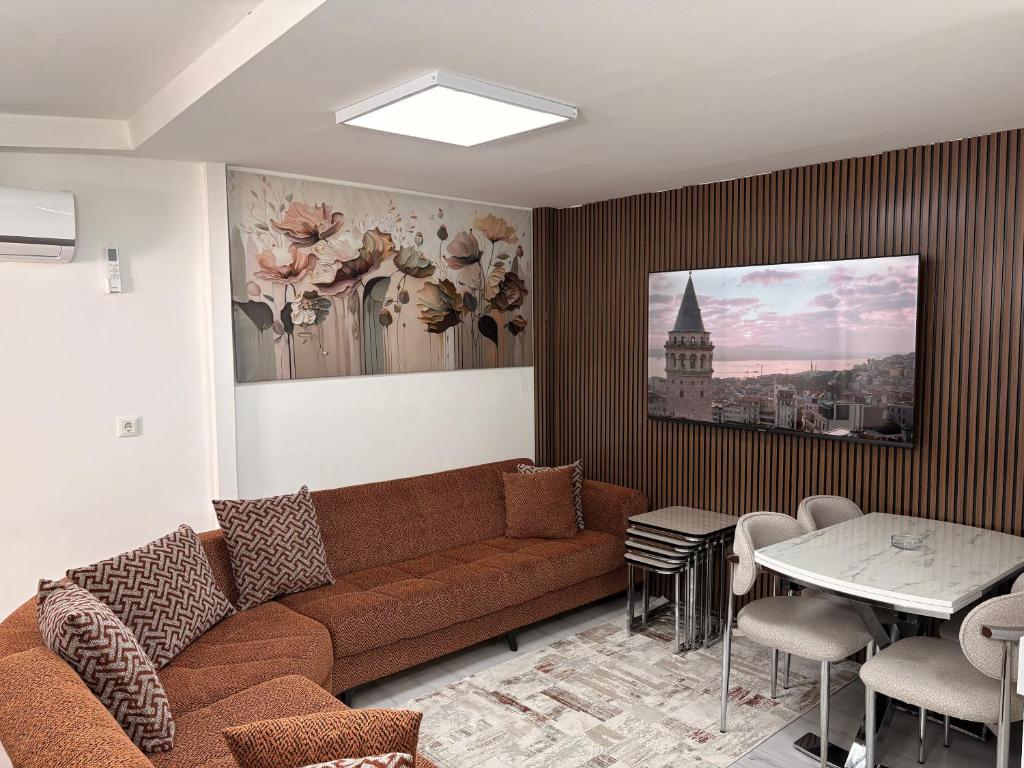 a living room with a couch and a table at Saklıkonak Otel in Isparta