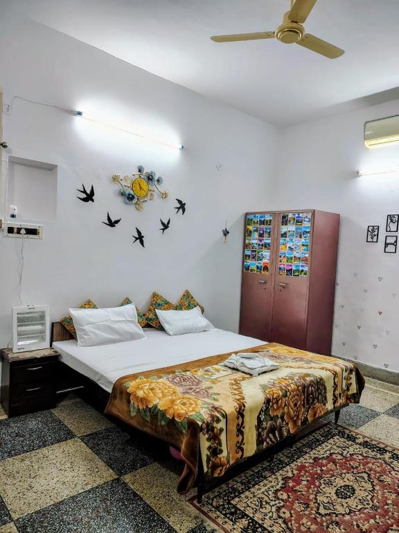 a bedroom with a large bed with birds on the wall at The Rest Nest in Gorakhpur