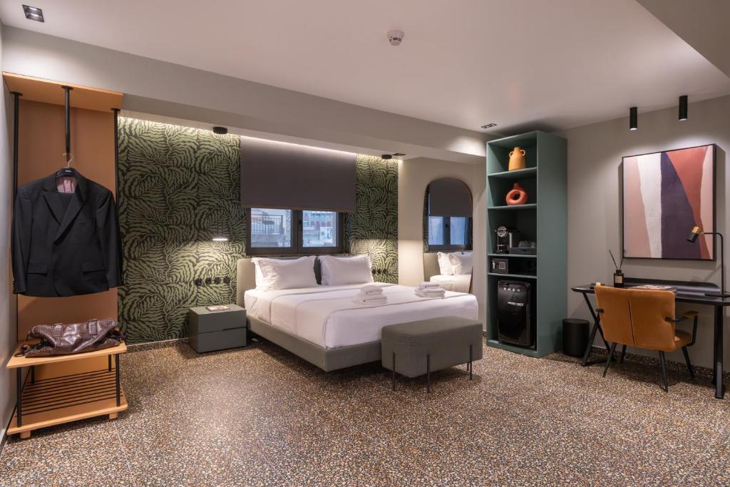 a bedroom with a large white bed and a desk at Athens Retro in Athens