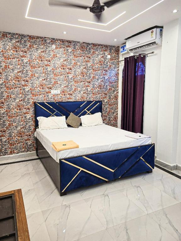 a bed in a room with a brick wall at Bajrangbali Guest House in Ayodhya