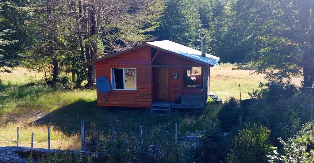 a small cabin in the middle of a field at Cabañas Entre Mañios y Coigües in Villa Santa Lucía