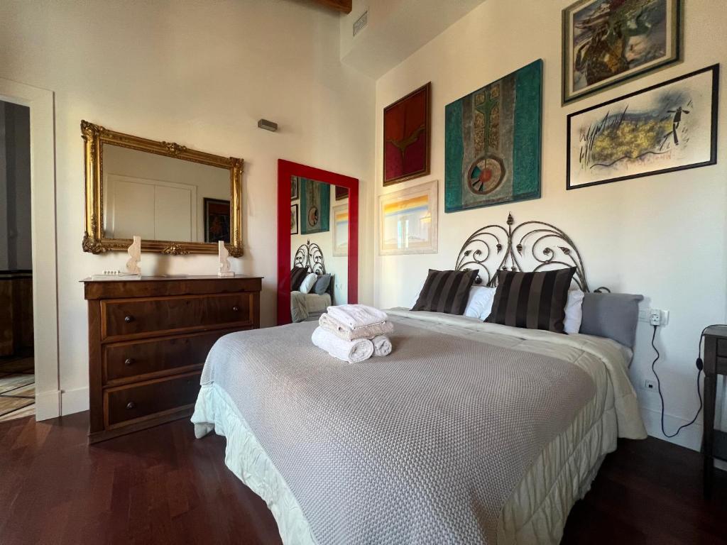 a bedroom with a bed with a dresser and a mirror at Beautiful Apartment Teatro Cervantes in Málaga