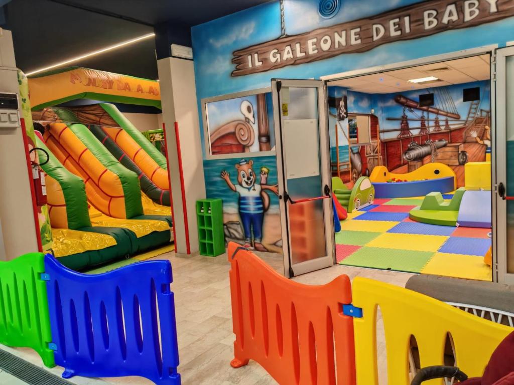 a childrens play room with a slide and slides at Hotel Sorriso in Lido di Classe