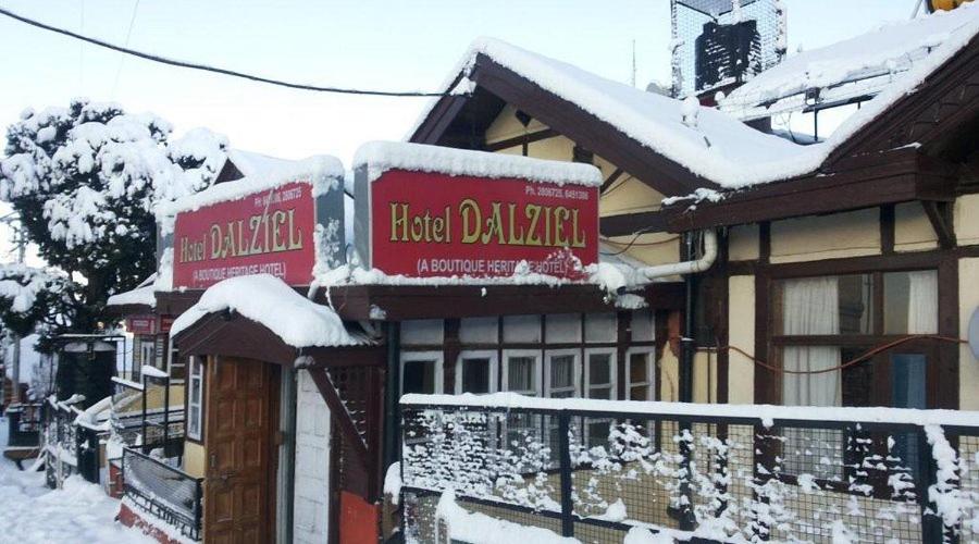a hotel dealer with snow on its signs at Hotel Dalziel in Shimla