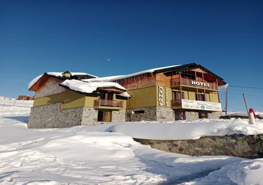 a building with a pile of snow in front of it at Kashmiri kitchens hotel in Gudauri