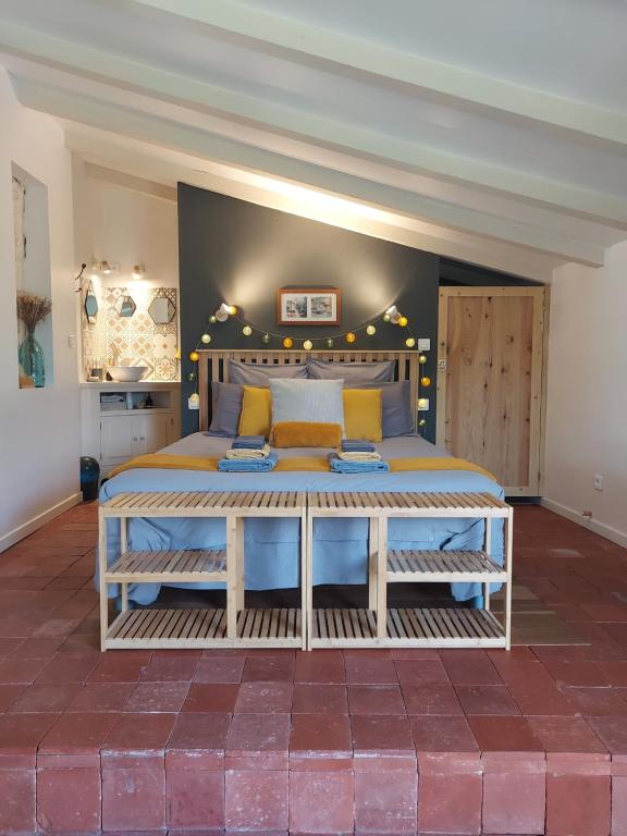 a bedroom with a large bed in a room at Chez Agatha in Vertheuil-en-Médoc