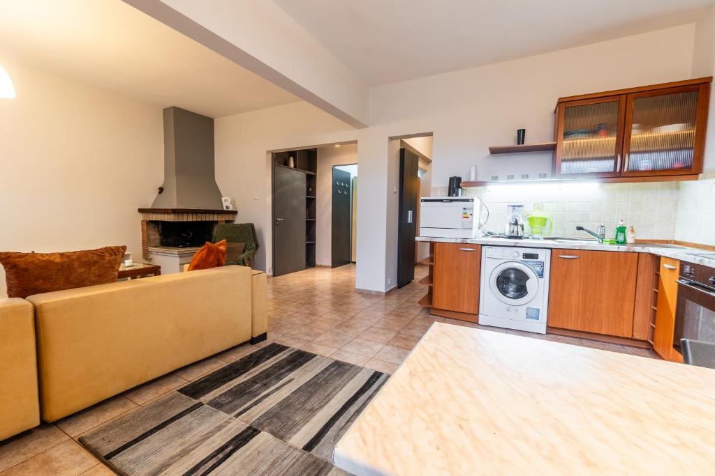 a kitchen and living room with a couch at National Stadium 1BR by BulgarianHomes in Sofia
